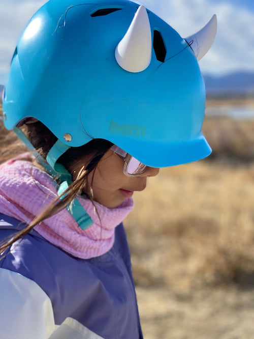 Small white devil horns on a bike helmet