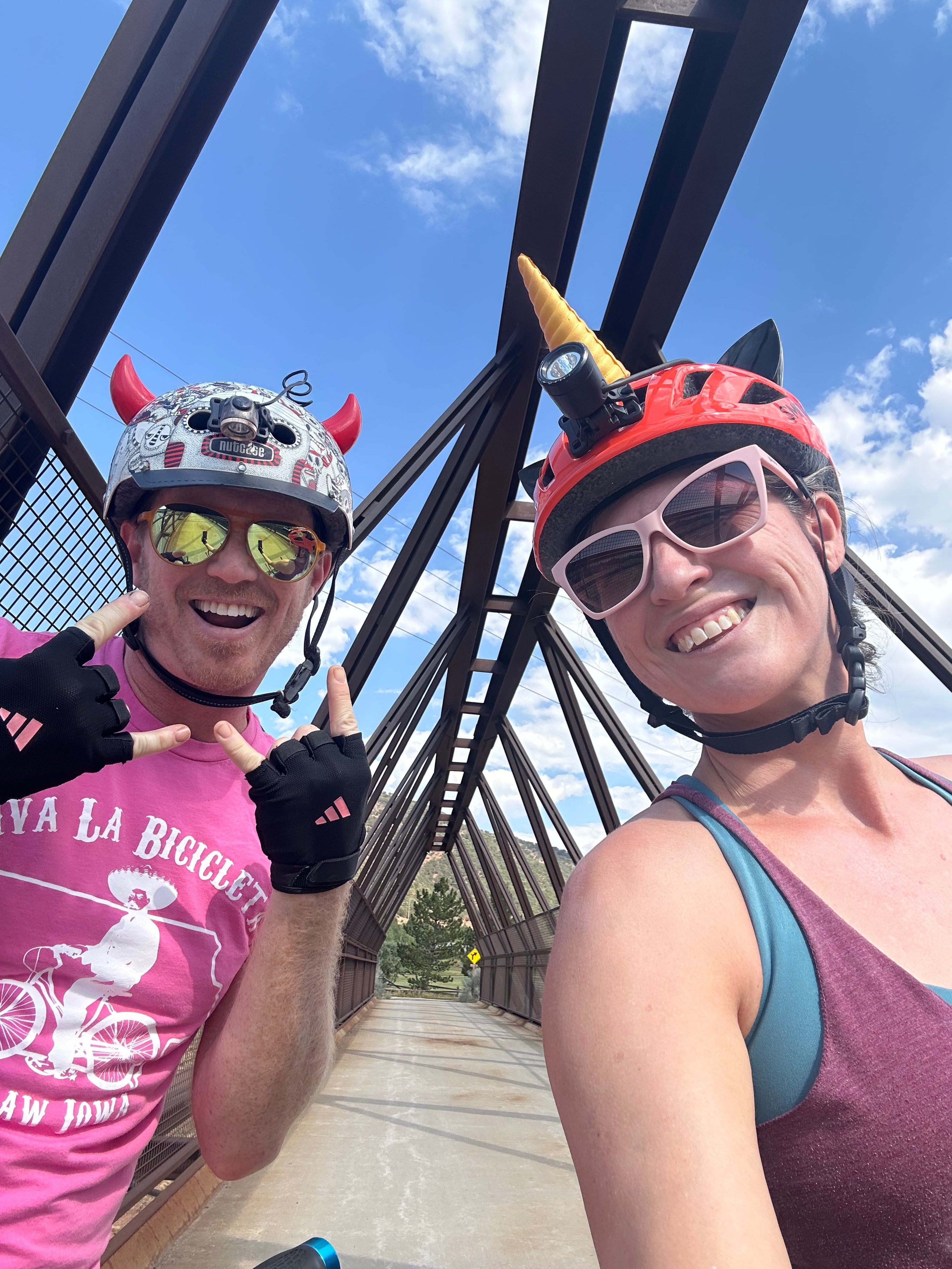 Two bike riders wearing helmets with Helmet Flair accessories for fun style and visibility