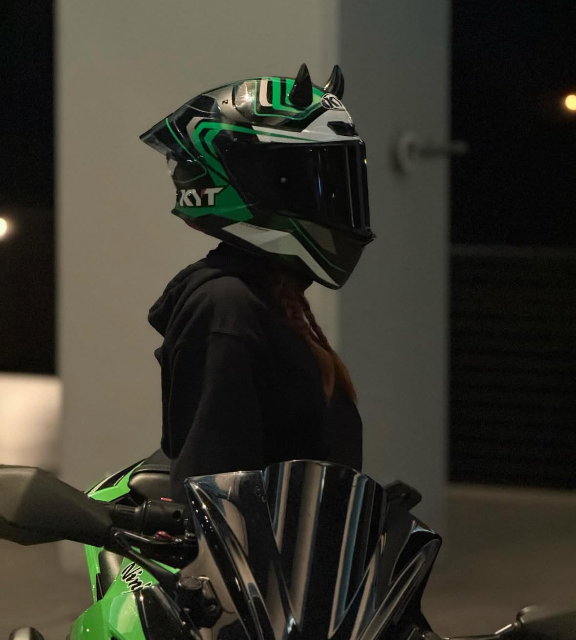 Motorcyclist riding with a custom helmet featuring Helmet Flair horns for visibility and personality