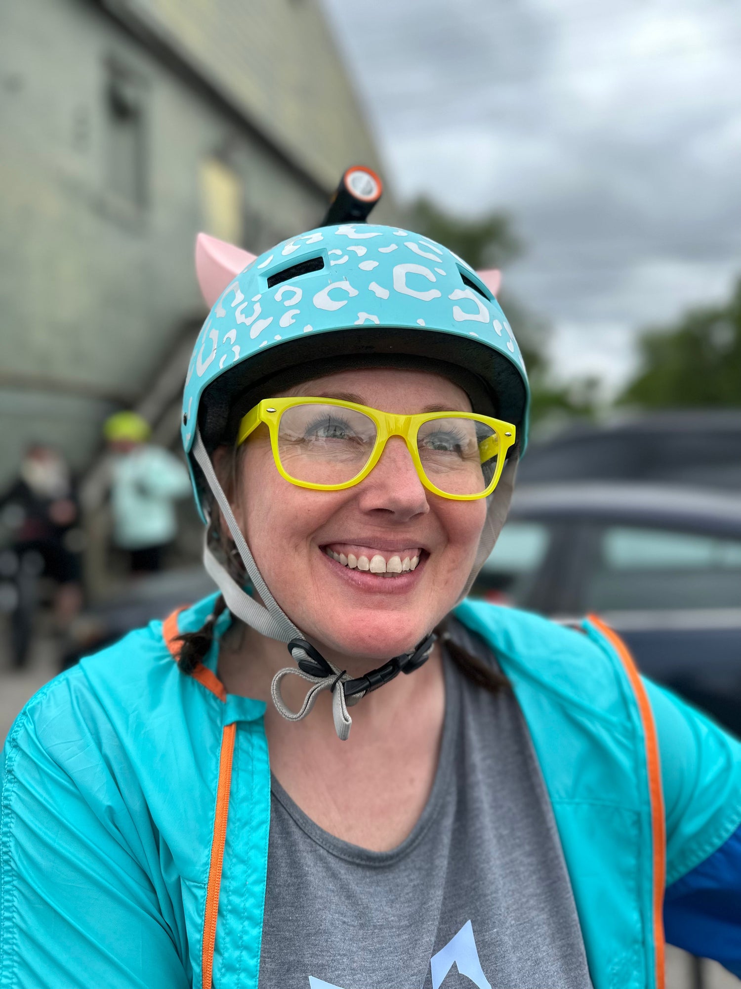 Cyclist wearing a helmet with pink kitty ear Helmet Flair accessories for fun style and visibility