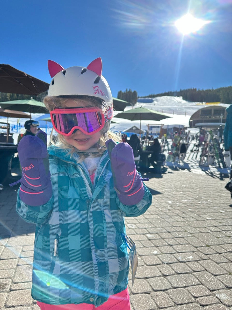 Little girl skiing on a slope wearing a helmet with purple kitty ear Helmet Flair Softeez accessories
