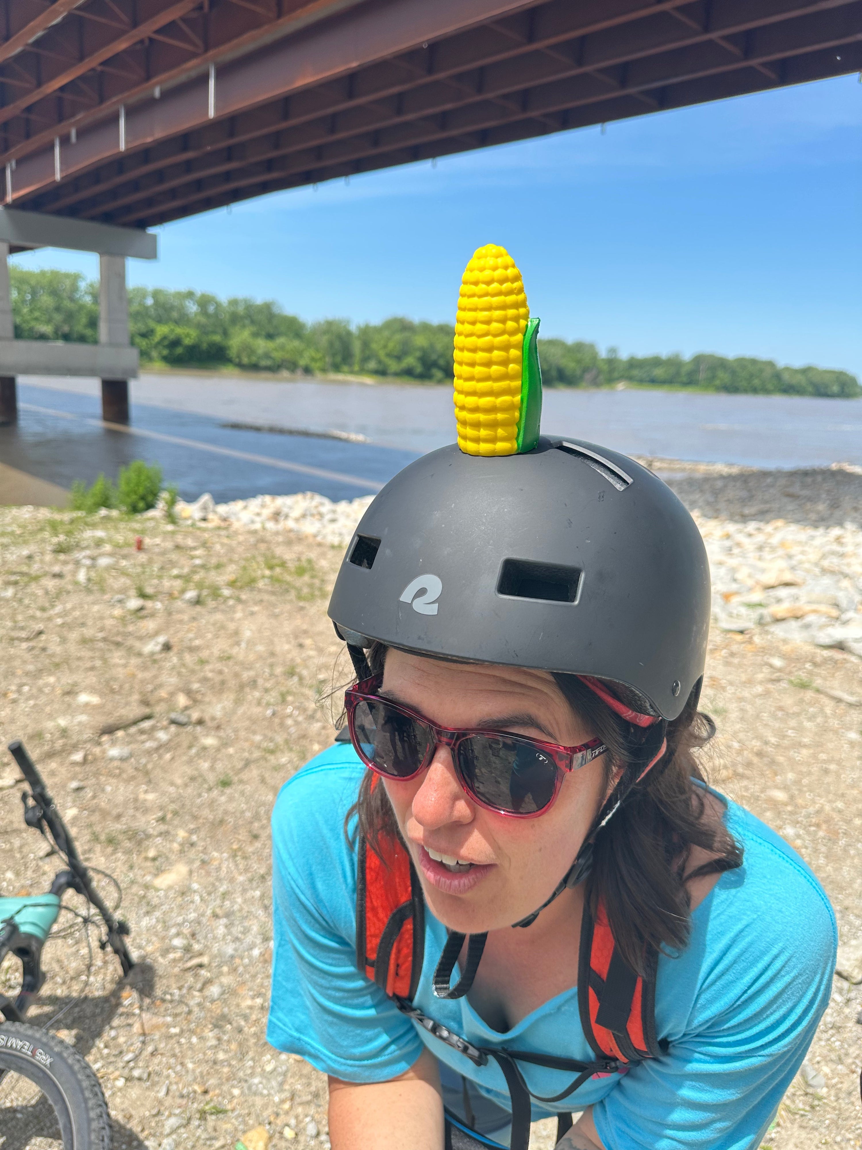 Girl wearing bicycle helmet with Helmet Flair Softeez corn cob