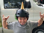 Kid with a unicorn mohawk on his helmet