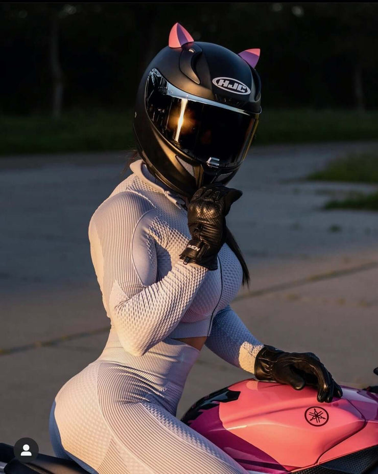 Pink kitty ears for motorcycle helmet girl with white outfit on a motorcycle