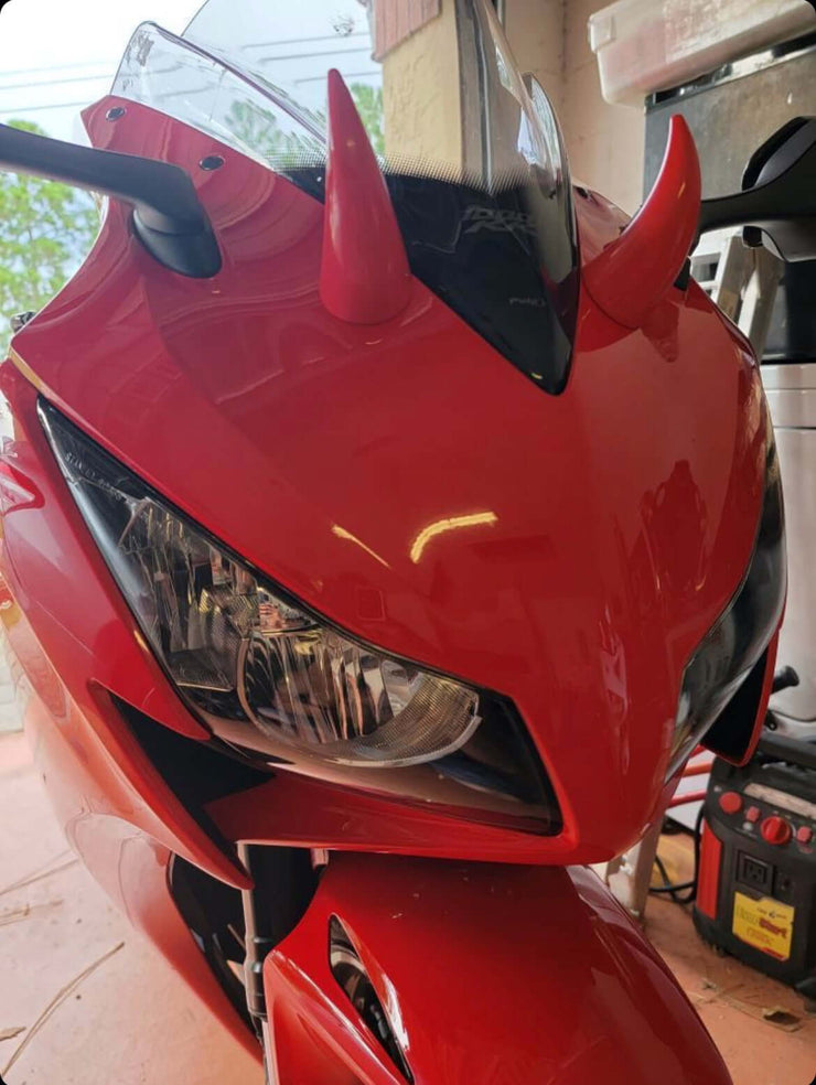 Large red horns mounted on a red motorcycle