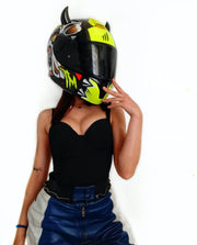 Small black horns on a motorcycle helmet worn by a woman in a black tank top