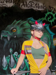 Woman wearing small red horns on her bicycle helmet