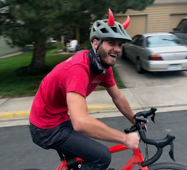 Large red devil horns on a bike helmet