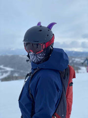 Large purple devil horns on a snowboard helmet