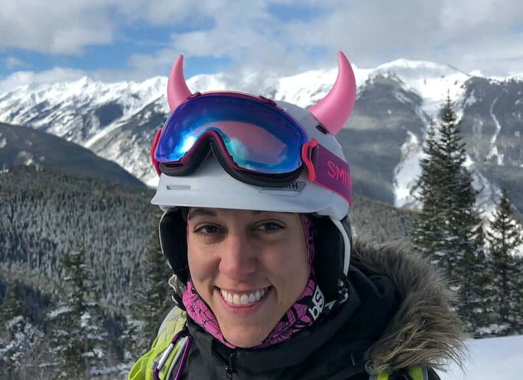 Large pink devil horns on a snowboard helmet