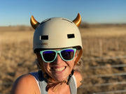 Small gold devil horns on a bike helmet